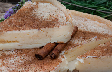 baked milk tart. a baked version of traditional South African milk tart or melktert, with cinnamon and rustic table