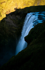Fototapeta na wymiar Top of skogafoss waterfall with viewpoint shadow