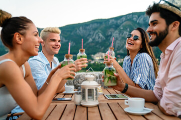 Leisure holidays vacation people and food concept. Happy friends having dinner at summer party