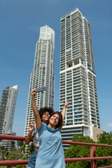 Fototapeta na wymiar Portrait of two latin woman friends taking selfie in Panama city, Panama