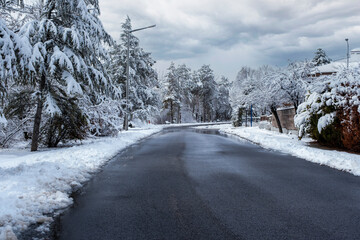 snow covered asphalt road and street in urban in February. Snowy and clear Weather. Selective Focus - Powered by Adobe