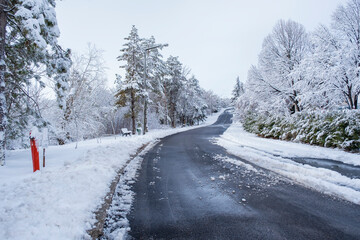 snow covered asphalt road and street in urban in February. Snowy and clear Weather. Selective Focus