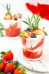 Delicious healthy breakfast, strawberry smoothie with natural yogurt and blueberries and rosemary