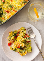 Delicious healthy vegetable pie with broccoli and cauliflower, tomatoes and sweet peppers and cheese in a plate