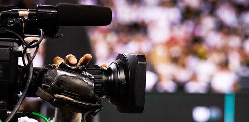 cameraman filming an event focus on camera