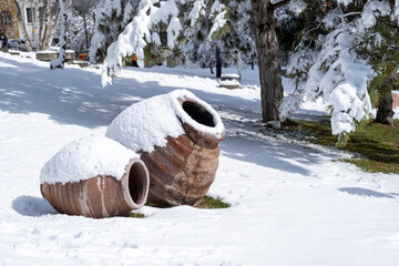 winter in Public Park at Ankara. decorative large clay pots in the snow covered garden. Selective Focus Pots
