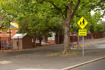 School crossing sign adjacent to a local school in the rural town of Ballarat - 500397401