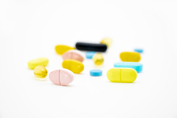 Different pills isolate on white background, side view, selective focus