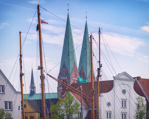 St Marienkirche by the Obertrave river with ship masts, copy space