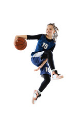 Full-length dynamic studio shot of young girl, basketball player in blue uniform training isolated over white studio backgroud