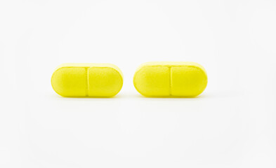 yellow pills isolate on white background
