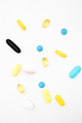 Different pills on white background, flat lay