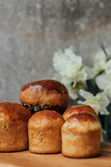 Delicious Easter cakes on a wooden table with flowers in the background. place for text. selective focus
