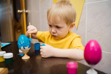 boy coloring an Easter egg