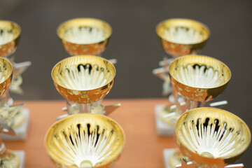 Winner's Cup. Gold Cups stand in row.