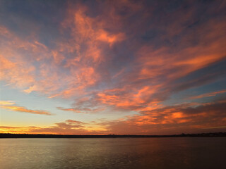 Sunrise over the lake, with red-orange clouds