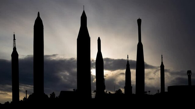 Merritt Island: Time Lapse at Sunrise with Fast Clouds and Dark Silhouette of Missiles in Kennedy Space Center Rocket Garden, USA