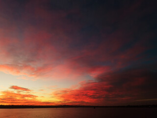 Sunrise over the lake, with red-orange clouds