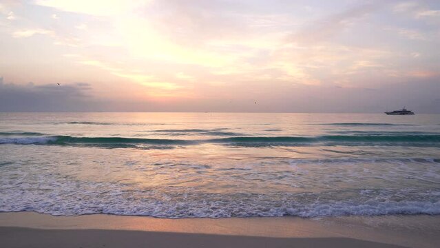 sunset beach with birds rin sky and yacht, summer