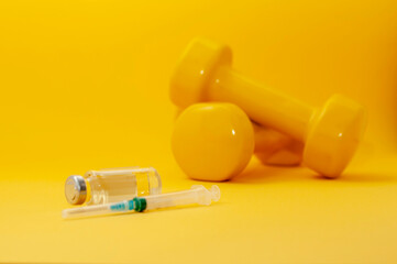syringe and a jar of clear liquid with dumbbells on a yellow background, a horizontal picture. the concept of doping in sports, steroids, testosterone and other drugs banned in sports. - obrazy, fototapety, plakaty
