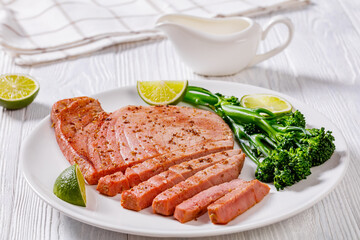 fried tuna steak with boiled broccolini and lime