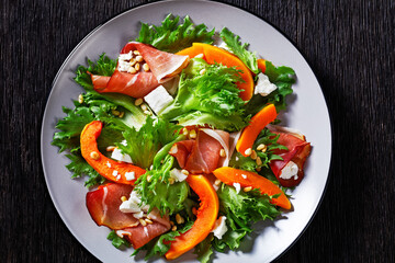 pumpkin salad with lettuce, crumbled cheese, ham