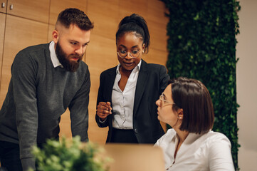 Multicultural team working together in office and having a meeting