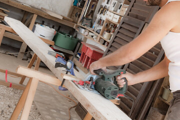 Man assembling furniture and fixing it - hobby garage concept.