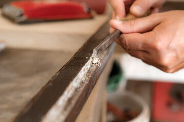 Man assembling furniture and fixing it - hobby garage concept.