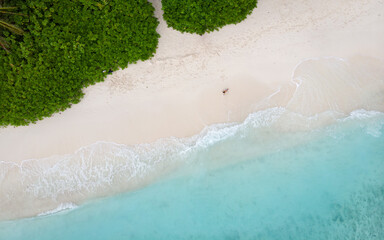 Fototapeta na wymiar Aerial top view from drone of beach with turquoise sea waves with copy space for text