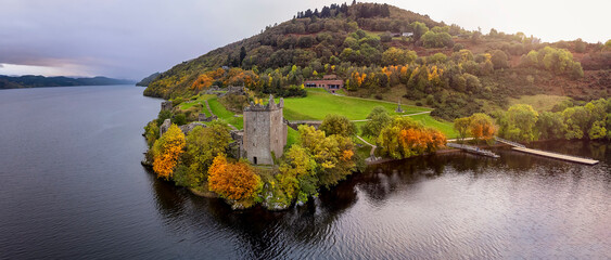 Fototapeta Aerial view of the ruins at Urquhart Castle at the Loch Ness during autumn sunset time, Scotland obraz