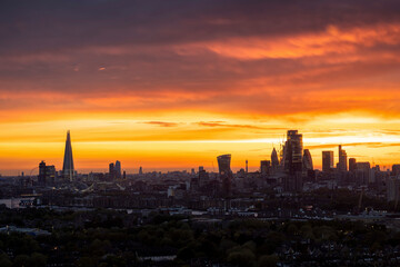 Colorful sunset view of the modern skyline of London, England, from Shoreditch, the City until...