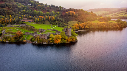 Aerial view of the beautiful Urquhart Castle at the Loch Ness during autumn sunset time, Scotland