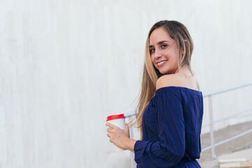 Middle-aged woman with disposable cup in park