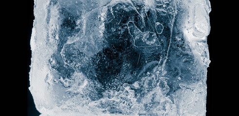 Ice texture background. Textured, dark blue-toned, the cold, cracked, frosty surface of an ice...