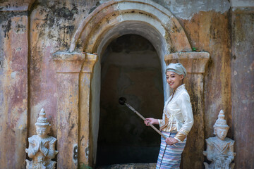 Beautiful Asian women dressed in traditional costumes visit Wat Palad or Wat Pha Lat temple ancient temples pray to the sacred according to Buddhist beliefs in Chiang Mai, Thailand.
