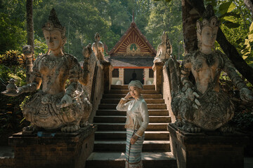 Beautiful Asian women dressed in traditional costumes visit Wat Palad or Wat Pha Lat temple ancient temples pray to the sacred according to Buddhist beliefs in Chiang Mai, Thailand.