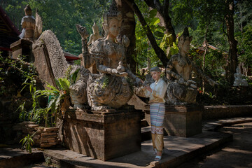 Beautiful Asian women dressed in traditional costumes visit Wat Palad or Wat Pha Lat temple ancient temples pray to the sacred according to Buddhist beliefs in Chiang Mai, Thailand.