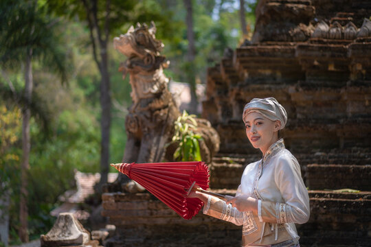 Beautiful Asian women dressed in traditional costumes visit Wat Palad or Wat Pha Lat temple ancient temples pray to the sacred according to Buddhist beliefs in Chiang Mai, Thailand.