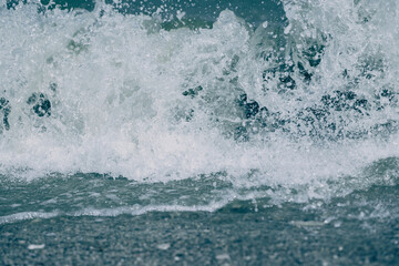 Naklejka premium Blue wave with white foam close-up. River, sea or ocean texture