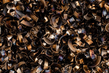 black pieces of metal and steel filings photographed in close-up macro in a metal factory