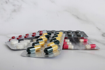 there are many different packages of blisters multicolored tablets and capsules of medicines for treatment and prevention