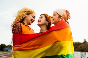Happy young girls celebrating gay pride festival - LGBT community concept