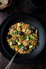 Lentil salad with quinoa, cherry tomato, broccoli, avocado, olives and vinaigrette sauce