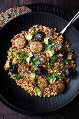 Lentil salad with quinoa, cherry tomato, broccoli, avocado, olives and vinaigrette sauce