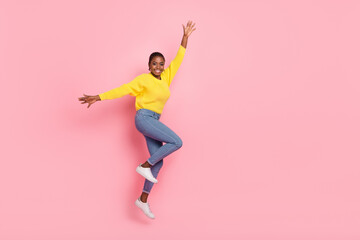 Full body profile side photo of young pretty cheerful girl jumper active isolated over pink color background