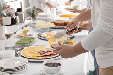 People taking food during breakfast, closeup. Buffet service