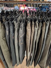 Lots of pants neatly arranged on the hanger