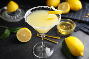 Delicious bee's knees cocktail and ingredients on black table