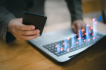 The concept of stock market investment, business growth, progress and success A businessman sat on his desk showing more and more Grammy stocks on a virtual screen, investing in trade profits.